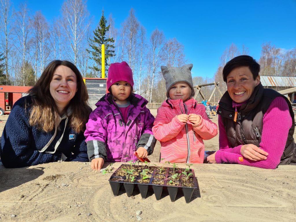 KLAR FOR PLANTING: Torsdag fikk barna i Tjura barnehage utlevert sine grønnsaksplanter fra Hanne Kure Bjustad i Grue Bondelag (til venstre) og Kjersti Rinde Omsted i Innlandet Bondelag (til høyre). Ine Haug og Oda Skara hadde mange spørsmål om grønnsaksplantene.