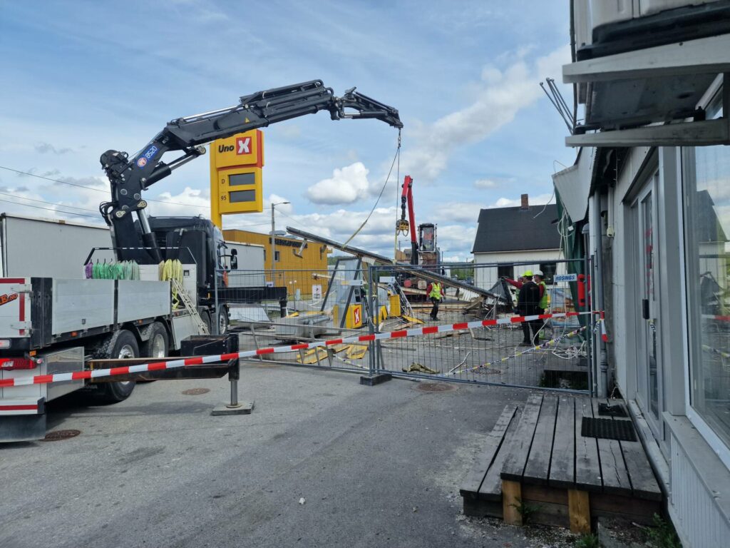 STORE KREFTER: Lastebilen som dro med seg taket har satt store krefter i sving. Mandag morgen var ryddingen i gang hos Uno X på Sundmoen.