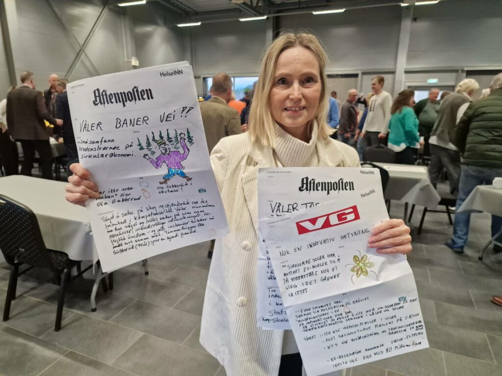 SKAL BRUKES: Kommunedirektør Anniken Baksjøberget viser fornøyd frem noen av avisforsidene, og forteller at gruppearbeidet skal brukes videre inn i arbeidet om fremtidens Våler.